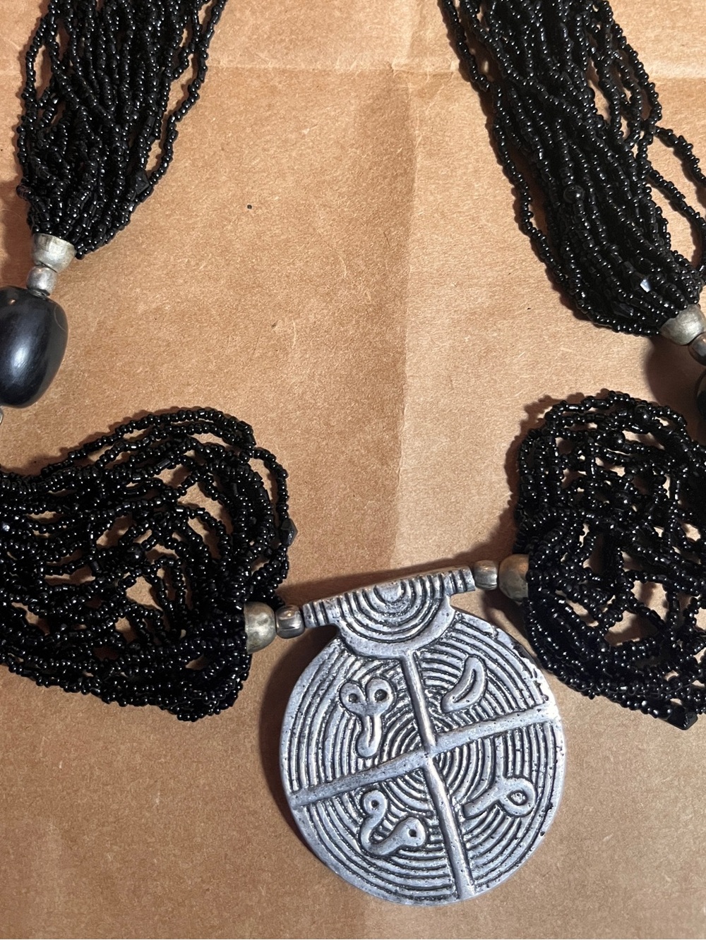 Handcrafted Black Beaded Necklace with Silver-Tone Tribal Pendant
